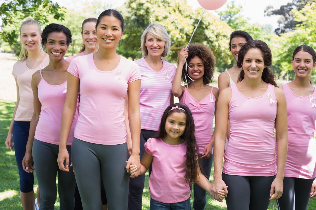 ladies smiling and wearing pink shirts